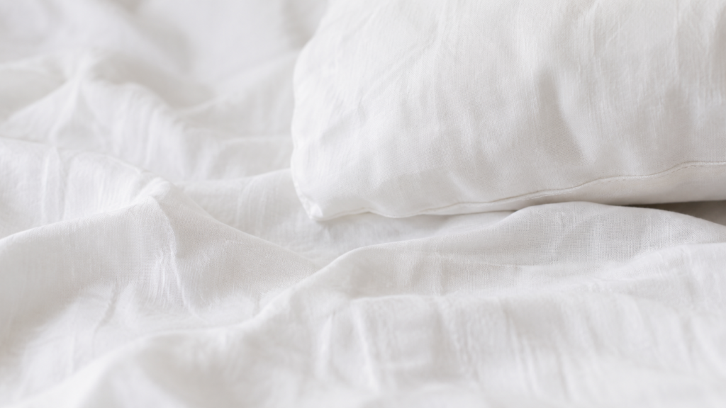 Breathable cotton bedding texture in soft natural light